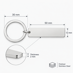 Silver stainless steel keychain with a round split ring and a rectangular blank tag, shown with dimension labels (30 mm ring diameter, 50 mm tag length, 12 mm tag height, 2 mm thickness) on a light gray background.