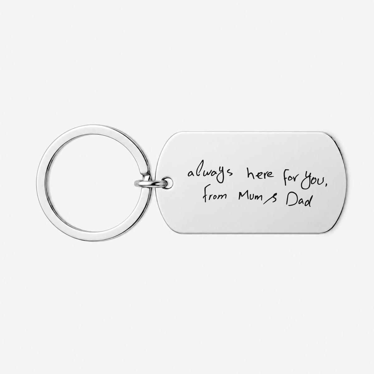 A silver metal keychain with a rectangular tag engraved with the handwritten text 'always here for you, from Mum's Dad' on a light gray background.